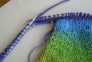 The working yarn has been knit across the second side of the sleeve